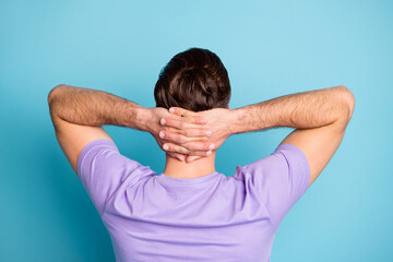 Sticker - Rear view photo of young handsome man rest relax pause break hands behind head isolated over blue color background