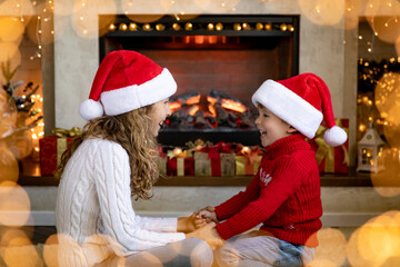 Canvas Print - Happy children near fireplace at Christmas