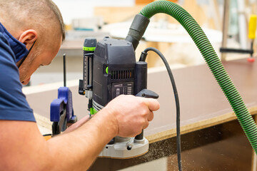 Electric milling cutter in the hands of a worker