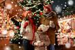 © Syda Productions - family, winter holidays and celebration concept - happy mother, father and little daughter with takeaway drinks at christmas market on town hall square in tallinn, estonia over snow