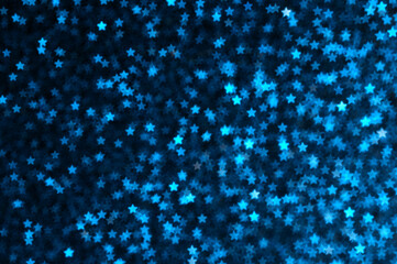 Blue holiday glitter background with stars bokeh.