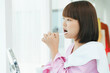 © THESHOTS.CO - Beautiful young asian thai black short hair woman brushing teeth with tooth brush in restroom.