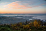 Fototapeta Na ścianę - sunrise on a background of mountains in the fog. autumn season.