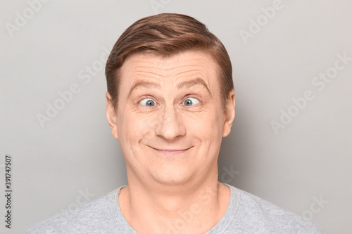 Cuadros en Lienzo Portrait of funny happy man making goofy face with crossed eyes