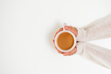 Female hands holding cups of coffee on white table background