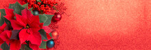 Red Poinsettia Flower And Festive Christmas Arrangement On Red Background. Top View, Copy Space. Xmas Banner.