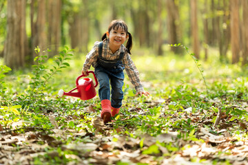 Asian kid Afforest plant sapling tree outdoors in nature spring for reduce global warming growth feature and take care nature earth.