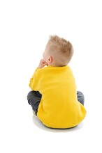 Back View Of Little Boy Sitting On Floor Looking Side At Copy Space. Rear View. Isolated On White Background 
