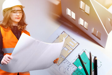 Wall Mural - Girl next to the construction drawings. Woman holds room plans in her hands. Concept - woman builder. Girl works in a construction office. Architect's desk. Concept - drawing up room plans.