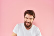 © SHOTPRIME STUDIO - Bearded man white t-shirt cropped view lifestyle studio pink background