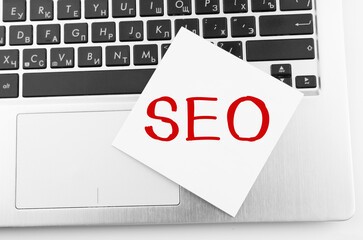 Poster - laptop with memo sticks on the keyboard with text seo on it.