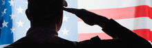 back view of patriotic military man in uniform giving salute near american flag on background, banner