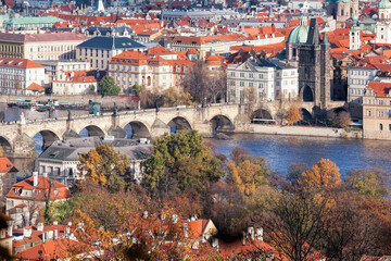 Fototapete - Charles bridge with autumn trees in Prague, Czech Republic