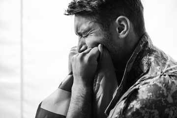 Wall Mural - military man in uniform crying while holding flag of america, monochrome