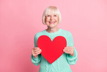 Photo Portrait Of Cute Grandmother Keeping Red Heart Symbol Of Love Isolated On Pastel Pink Color Background
