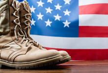 Army Boots Near American Flag On Blurred Background
