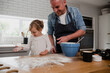 © Prins Productions - Father and daughter baking in the kitchen together making a mess