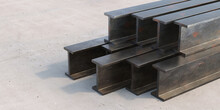 Steel Beams Stack On Cement Concrete Background. 3d Illustration