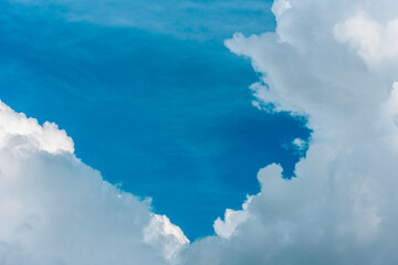 Bright blue sky with fluffy clouds in Carpathian mountains