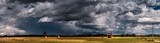 Fototapeta Tęcza - Dramatic view of a shelf cloud over a field, horizontal cloud formation, panorama view.