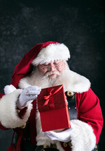Santa Claus Peeks Inside Red Gift Box