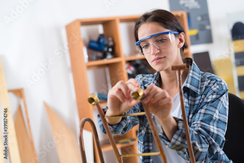 Fotomural Young plumber working with copper piping