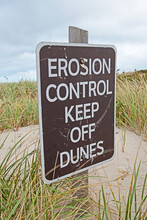 A Sign On Sandy Neck Beach In Massachusetts Warns People To Stay Off The Sand Dunes In Order To Help Prevent Their Erosion.