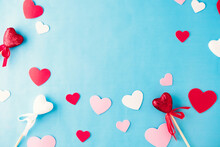 Red And Pink Hearts In Frame On Blue Background For Valentine's Day.