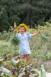 © Angelina - A little, cute girl in a blue sundress runs with an orange carrot in her hands