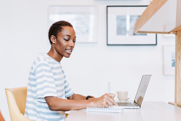 Poster - Black lady taking a note in a meeting