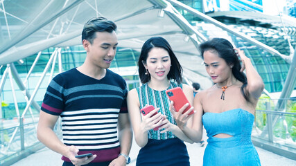 Wall Mural - Three asian young friends enjoy outdoor time visiting a new city