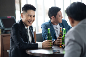 Wall Mural - Group Of Asian Friends Enjoying Evening Drinks in bar. Celebration, Party People Christmas and Happy new year concept. Asian business people in party.