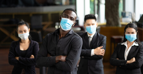 Wall Mural - Portrait Of Business Team waring face mask inside modern Office. Group of diverse business people with African American businessman leader.