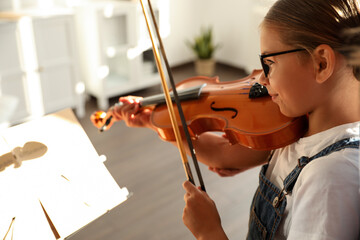 Poster - Cute little girl playing violin indoors, closeup. Music lesson