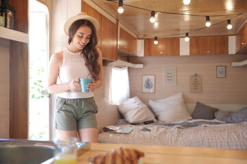 Sticker - Young woman with cup in trailer, space for text. Camping vacation