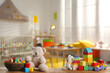 © New Africa - Set of different cute toys on wooden table in children's room. Space for text