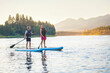 © Brocreative - Family Paddle boarding together on a Beautiful Mountain Lake