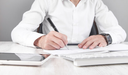 Poster - Businessman writing on paper in office.