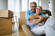 © NDABCREATIVITY - Portrait of happy senior couple in love moving in new home