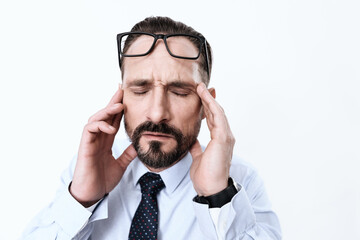 A man massages his head from a severe migraine. 