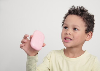 Wall Mural - little boy with bar of soap washing hands keeping safe from coronavirus stock photo