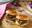 Slow cooker pulled beef sandwich with cheese,  pickles, caramelized red onions and cheese