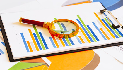Poster - magnifying glass on business graph on white background