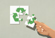 © fStop - Hand finishing recycling symbol jigsaw puzzle with missing piece