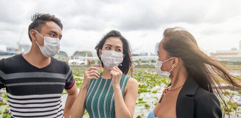 Sticker - Three happy young asian friends outdoor wearing face mask in covid pandemic