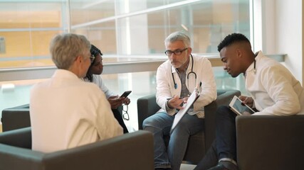 Wall Mural - Medical people sitting in meeting room, checking planning together