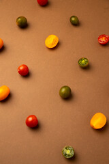 Wall Mural - various kinds of mini tomatoes on brown background