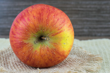 Wall Mural - Red apple on the table, close-up