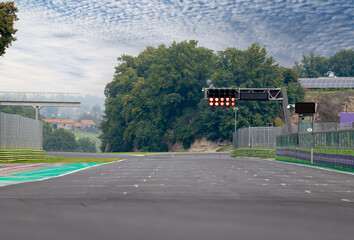 Wall Mural - Red light on motor sport straight starting line asphalt track