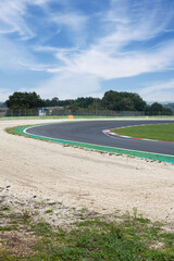 Wall Mural - Asphalt track turn with gravel trap on empty motor sport circuit